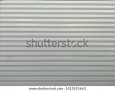 Horizontal image texture from grey roller steel garage door 