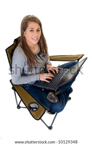 trendy attractive female teenager student doing schoolwork on laptop, studio shot, white background,