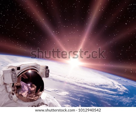 Space and sunrise. Astronaut in cosmos. The elements of this image furnished by NASA.
