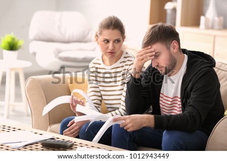 Couple arguing about money at home. Problems in relationship Royalty-Free Stock Photo #1012943449