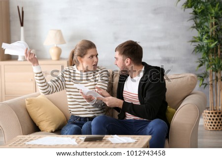Couple arguing about money at home. Problems in relationship Royalty-Free Stock Photo #1012943458