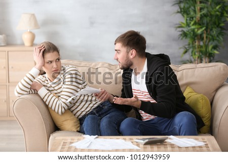 Couple arguing about money at home. Problems in relationship Royalty-Free Stock Photo #1012943959