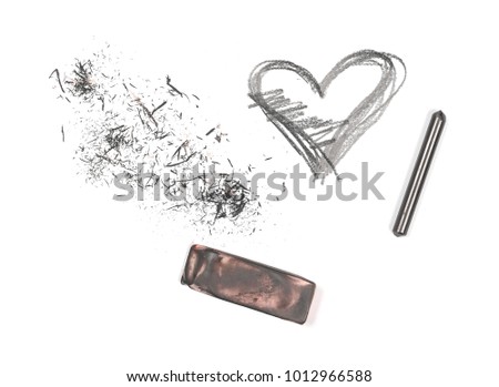 Graphite pencil and eraser with shavings isolated on white background, top view