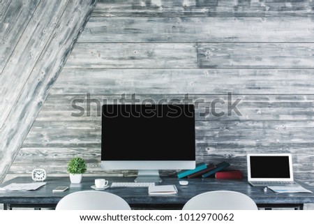 Close up of modern workplace with blank computer monitor, stationery items and other objects. Design and advertisement concept. Mock up 