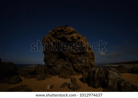 Magnificent rock with the beautiful starry night background - summer night at the Australian ocean beach