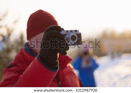 Man takes pictures on a film camera