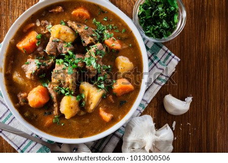 Irish stew made with beef, potatoes, carrots and herbs. Traditional  St patrick's day dish. Top view Royalty-Free Stock Photo #1013000506