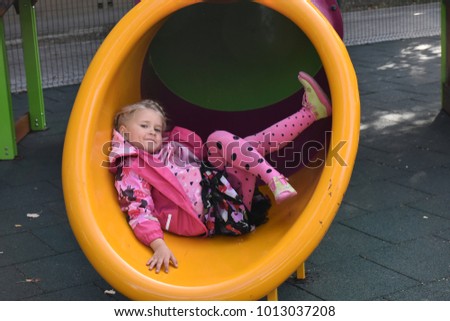 the child is playing on the playground