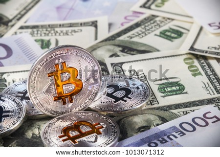 coins of bitcoin on the background of banknotes of dollars and euros. bitcoin the most Popular cryptocurrency in the world