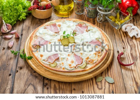 Italian pizza with cheese, on a wooden table