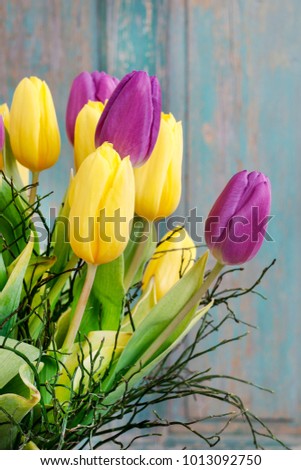 Bouquet of yellow and violet tulips.