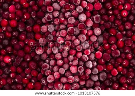 Frozen cranberries on a red background the white band across looks like a flag.