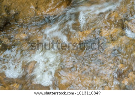 Mountain river with fast water current. River water photo texture. Green river in tropics wallpaper. Still rippled water of fresh spring in forest. Rippled river texture. Natural water current