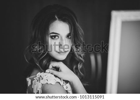 Portrait of a beautiful young woman. Makeup and hairstyle in bride. Close up. Wedding morning. Gentle, Tender emotion on the face. Black and white photo.