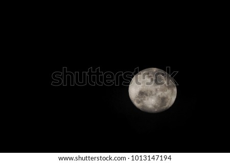 Full moon over dark black sky at night

