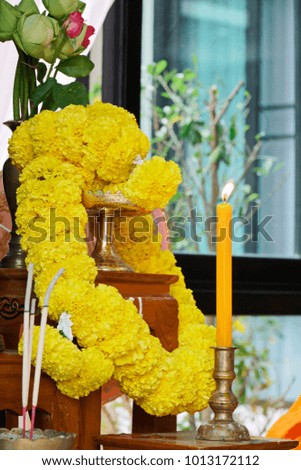Marigold flower garland, incense stick and candles