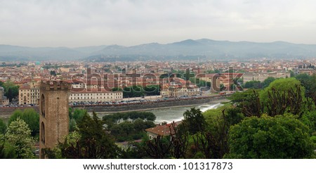 Panoramic shot of Florence seen from Michelangelo square: Old Tower, Arno River and hills in the horizon.