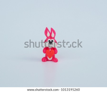 Pink clay rabbit cartoon hold red heart on hand white background concept valentine day , easter day