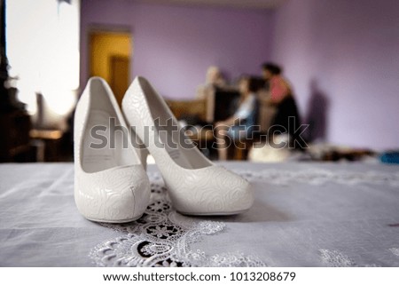 White wedding shoes in bride's room close