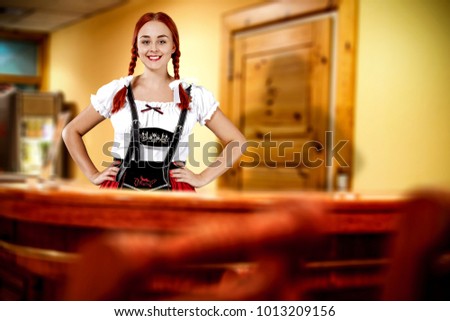 Young slim bavarian woman and her own small business. Hotel interior. 