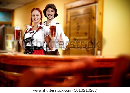 Two young bavarian people and their own small business. Hotel interior with reception. 