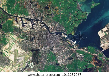 Amsterdam, the capital of the Netherlands, seen from space - Modified elements of this image furnished by ESA  Royalty-Free Stock Photo #1013259067