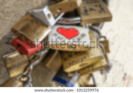 blurred background with love symbol padlocks chained on bridge