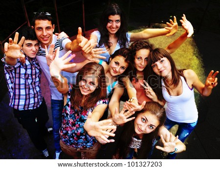 A group of young people dancing at a disco. Royalty-Free Stock Photo #101327203