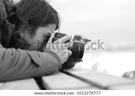 The photographer man is shooting in black and white photo.