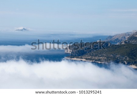 Aerial photography of big rock on the sea with a cloudy atmosphere. 
