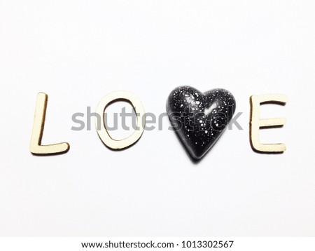 LOVE dark chocolate in heart shape  and Macarons on white background. Concept for Valentine’s Day