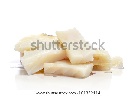 some pieces of raw cod on a white background