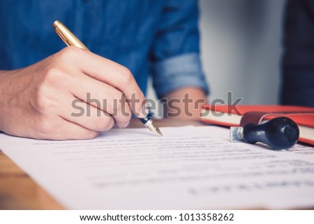 Close up business man reaching out sheet with contract agreement proposing to sign.Full and accurate details, individual who owns the business sign personally,director of the company, solicitor.
