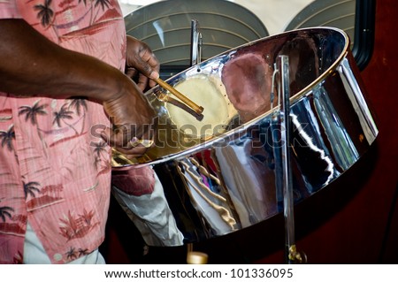 close up of man playing a steel drum Royalty-Free Stock Photo #101336095