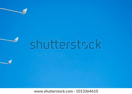 Bottom view of three spotlights against blue sky background,on brightening day,concept selfie stick sky on summer.