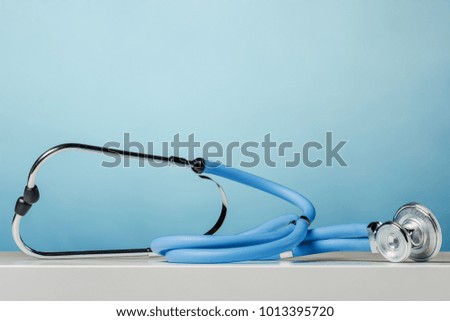 Blue medical stethoscope on a desk front view