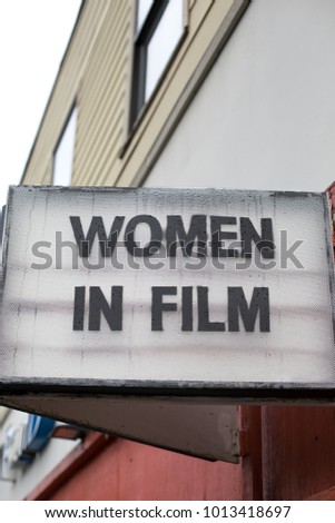 Marquee sign outside of an old movie theater advertising a festival for Women In Film