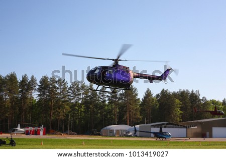 The aircraft - the voilet helicopter at competitions makes flight at low height.