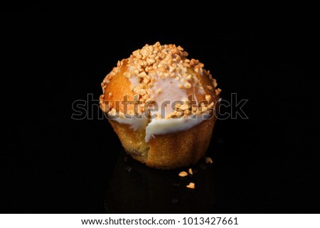 Cupcake muffin with peanuts on a dark background