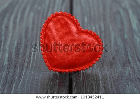 Tissue red heart on a wooden background