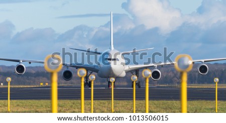 white airbus A340-300 at the end of the runway Royalty-Free Stock Photo #1013506015