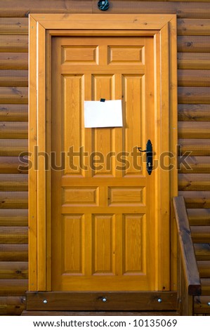 Rustic wooden door with a sign blank