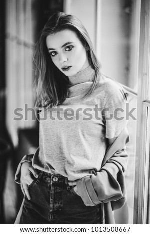 Close up portrait of attractive brunette teen girl with posing in stylish casual clothes. Fashion photo shoot. Black and white