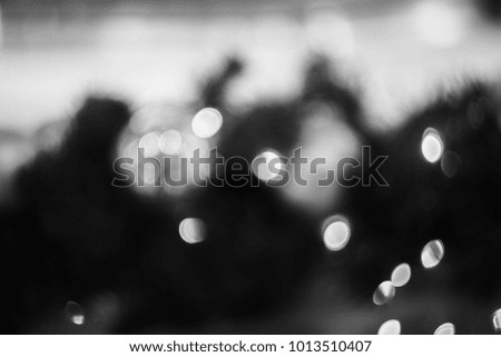 Festive elegant abstract background with bokeh lights and stars, black and white