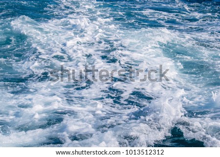 Boat leaving the foam trails in the sea in the sunny day. Sea wave texture.  Royalty-Free Stock Photo #1013512312