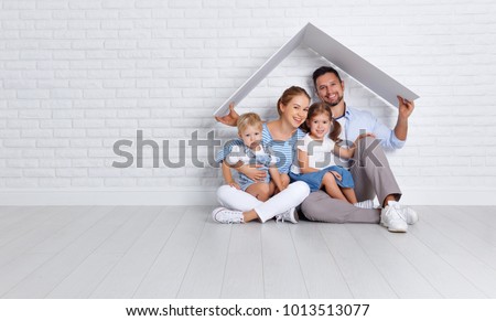 concept housing a young family. mother father and children in a new home Royalty-Free Stock Photo #1013513077