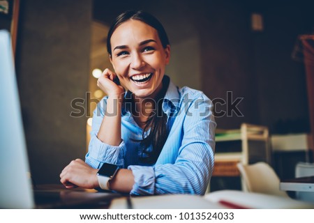 Cheerful brunette woman laughing on joke while networking searching information for project on laptop computer,happy female having fun during distance job in cafe interior completing successful task Royalty-Free Stock Photo #1013524033