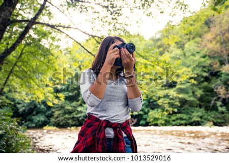 Young tourist with camera outside