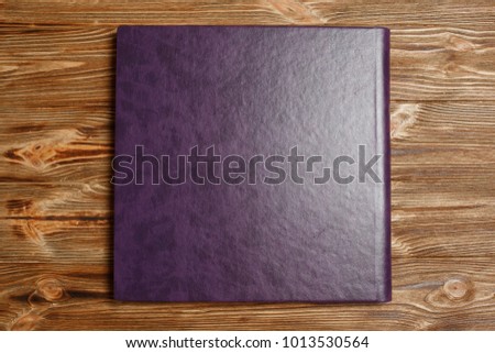 photo book with a hard cover on a wooden surface.
purple photo album with leatherette.
wedding photo album.
Expanded photobook pages.

