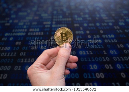 Gold beatlock. New virtual money. Crypto currency in hand. Defocus.